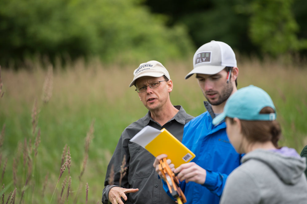 students and instructor in field