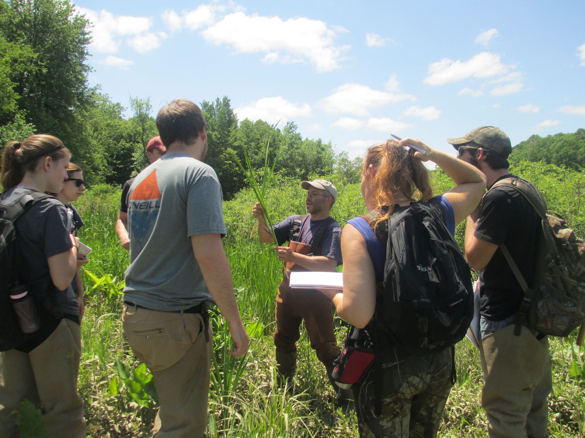 instructor talking to students on a bog